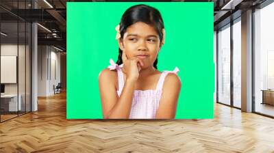 Thinking, green screen and idea by child with a question feeling excited, thoughtful and isolated in studio background. Planning, girl and joyful kid is happy, curious and planning expression Wall mural