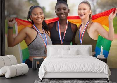 Athlete, together and medal in portrait with flag, rainbow or support for LGBTQ, human rights or equality. Women, people and champion with team, sign or solidarity for win at global sport competition Wall mural