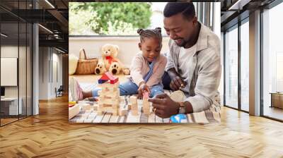 Black man, play and building blocks with girl learning from father on floor of living room. Kid, growth and toys for child development with dad teaching daughter in home lounge for education Wall mural