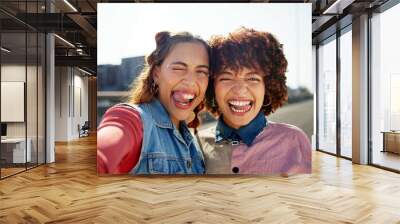 Outdoor selfie, people and goofy portrait in city, photography and confident for street fashion. Women, friends and tongue out for comedy in relationship, gen z style and social media post on weekend Wall mural