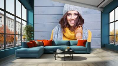 beautiful natural young smiling brunette woman wearing knitted sweater, leather gloves, scarf and ha Wall mural