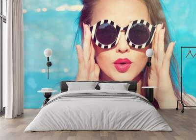 Colorful portrait of young attractive surprised woman wearing sunglasses. Summer beauty  concept Wall mural