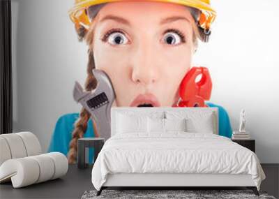 surprised woman wearing a hardhat holding pliers and spanner Wall mural