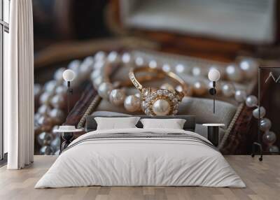 A gold ring and pearl necklace are displayed in a wooden box Wall mural