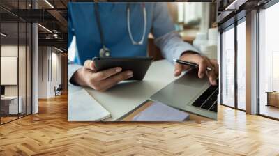 Doctor work on digital tablet healthcare doctor technology tablet using computer in a modern office  in the morning at the desk. Wall mural