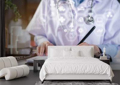 Female doctor working on desk with laptop computer and paperwork in the office. Medical and doctor concept. Wall mural