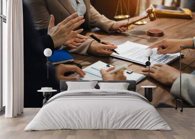 Teamwork of business lawyer meeting working hard about legal legislation in courtroom to help their customer.. Wall mural