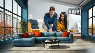 Two young asian woman work in back office for checking the product in the warehouse, concept e commerce. Wall mural