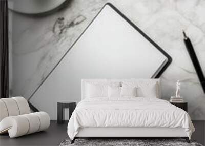 A neatly arranged flat lay of office supplies, including two coffee cups and an empty notepad, on a marble desk Wall mural