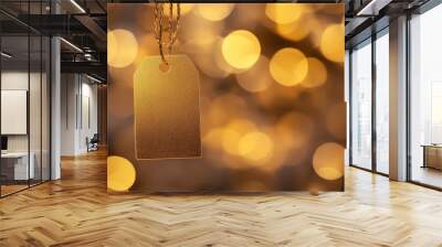 A shimmering gold price tag hangs elegantly, illuminated by a soft bokeh backdrop of warm, golden hues Wall mural