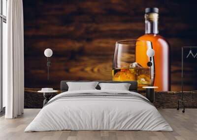 Whiskey glass and bottle on the old wooden table Wall mural