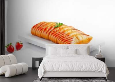 Close up of a single glazed bread roll on a white rectangular plate, with two strawberries in the foreground. Wall mural