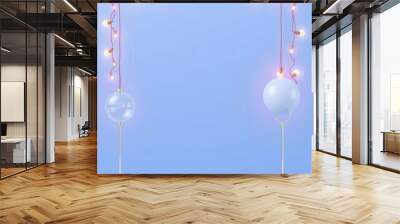 Two Christmas ornaments on stands with string lights on blue background. Wall mural