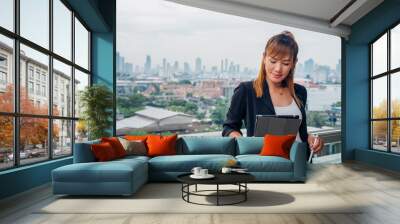 vintage style, Young business woman with tablet in the office against panoramic windows Wall mural