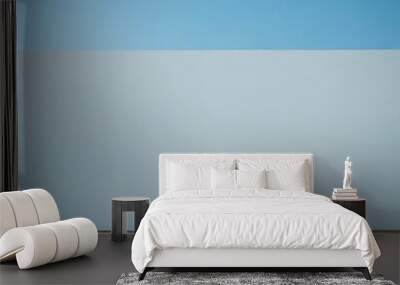 A minimalist image of a white wall with a blue sky in the background, set against a concrete floor. Wall mural