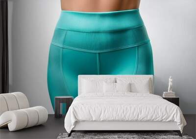 A pair of turquoise leggings, isolated on a white background Wall mural