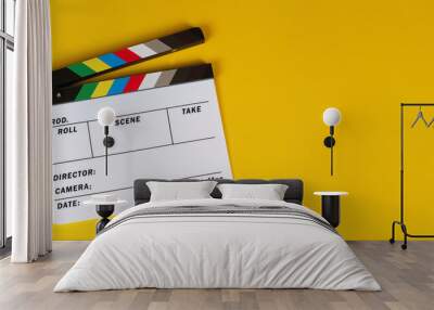 Clapper board or movie slate on yellow background. Wall mural