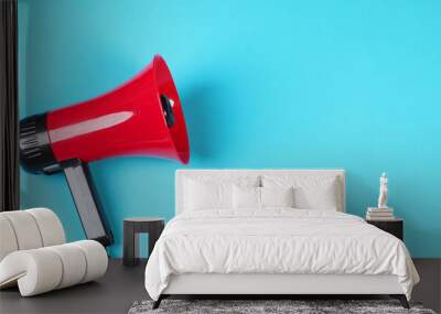 Red megaphone isolated on blue background. Wall mural