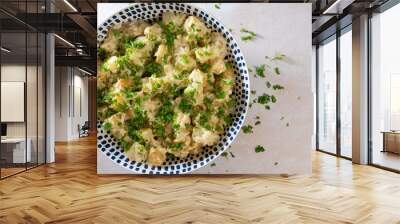 Fesh homemade creamy potato salad seasoned with finely chopped parsley in a large bowl made with new baby potatoes gemson variety. Top view. Wall mural