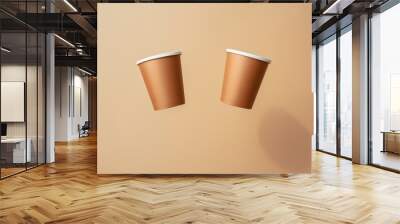 Flying brown Two Paper cup suspend mid-air , a light brown background, Coffee, zero waste. Wall mural