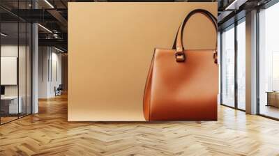 Woman s leather handbag placed on a smooth beige background, elegant and stylish, fashion accessory focus Wall mural