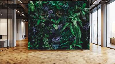 beautiful nature background of vertical garden with tropical green leaf Wall mural