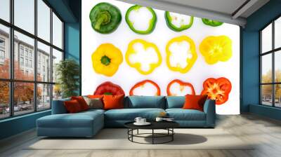 Green, red, yellow pepper, cut into pieces, put together on a white background Wall mural