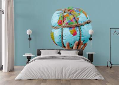 man holding a tied earth globe, web banner Wall mural