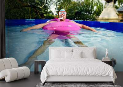 man swimming in a portable swimming pool Wall mural