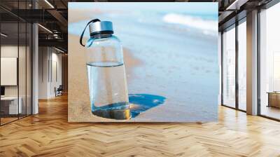 reusable water bottle on the beach Wall mural