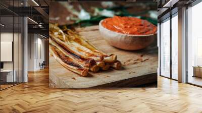 roasted calcots typical of Catalonia on a table Wall mural