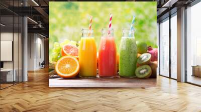 bottles of fruit juice and smoothie with fresh fruits Wall mural