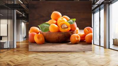 bowl of fresh ripe apricots with leaves Wall mural