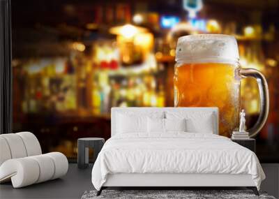 cold mug of beer in a bar on wooden table Wall mural