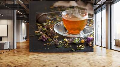 Cup of herbal tea with various herbs Wall mural