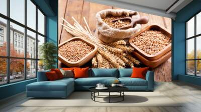 grains and wheat ears on a wooden table Wall mural