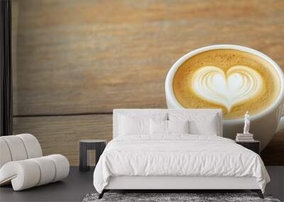 Close up hot cappuccino white coffee cup with heart shape latte art on dark brown old wood table at cafe,food and drink concept Wall mural