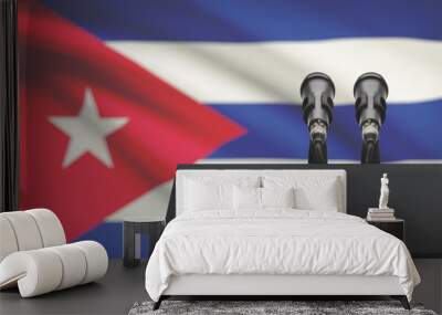 Pulpit and two microphones with a national flag on background - Cuba Wall mural