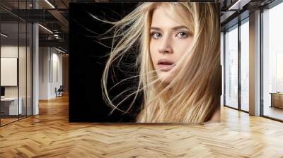 Beautiful young blonde girl with flowing hair.  Wall mural