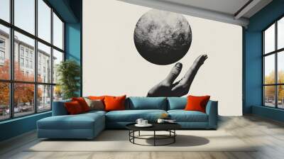 Hand holding floating planet in minimalistic black and white artwork, creative surrealism concept Wall mural