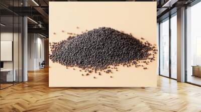 Pile of black poppy seeds on beige background, close-up. Culinary ingredient and healthy eating concept Wall mural