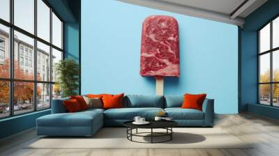 Raw steak on a popsicle stick against a blue background, surreal food concept Wall mural