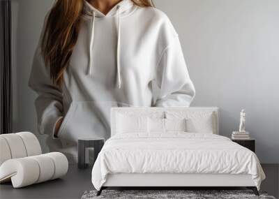 Woman in white hoodie with front pocket and drawstrings, casual fashion clothing concept Wall mural