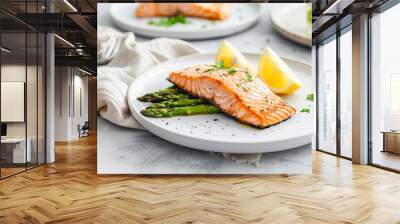 A delicious salmon fillet with asparagus served on a white plate for a healthy meal Wall mural