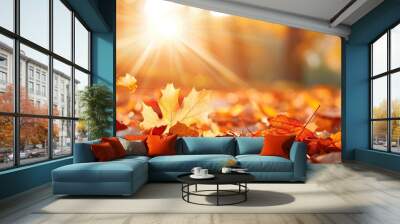 Falling leaves in autumn with sunlight illuminating the vibrant golden and orange colors Wall mural