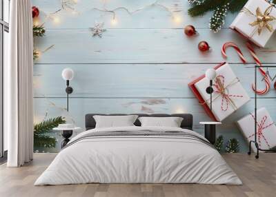 Holiday gift box with red ribbon and candy canes on white wood featuring copy space Wall mural