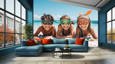 Kids ready for summer adventure wearing vibrant goggles and flippers on the sand Wall mural