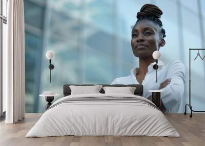 Professional black businesswoman standing with crossed arms outside a contemporary office building Wall mural