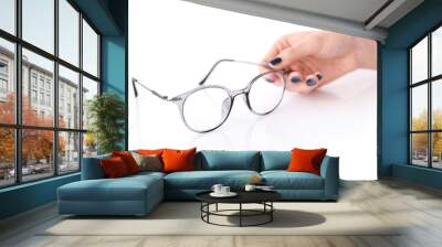 Beautiful glasses whit female hand on white background Wall mural