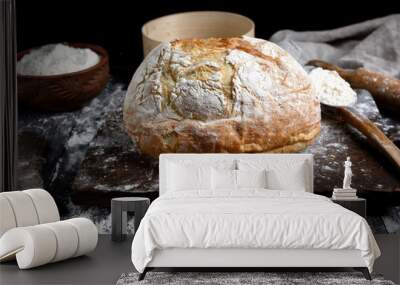 baked round white wheat bread on a brown wooden board Wall mural